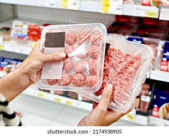 Buyer woman chooses chopped meat in a shop - Powered by Shutterstock