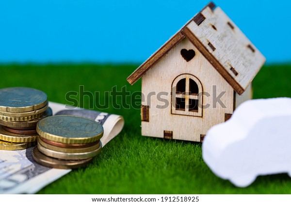Buying a car or a house,\
building repair and mortgage concept. Estimation real estate\
property with loan money and banking. Car credit and insurance. Toy\
house and cash
