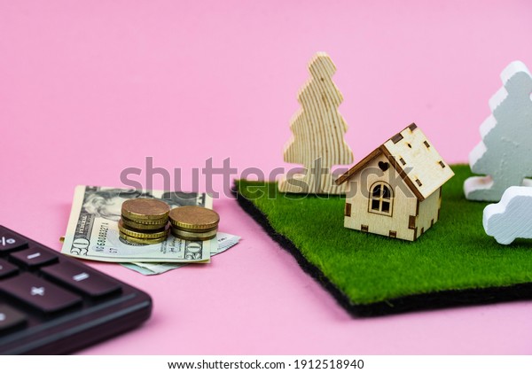 Buying a car or\
a house, building repair and mortgage concept. Estimation real\
estate property with loan money and banking. Car credit and\
insurance. Toy house, calculator and\
cash