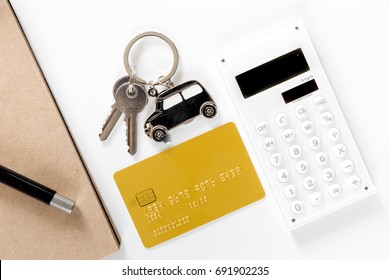 Buying Car. Car Keys And Bank Card On White Background Top View