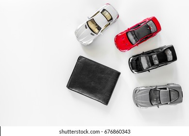 Buying Car. Toy Cars And Wallet On White Background Top View Copyspace