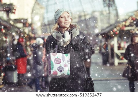buying Christmas gifts girl snow outside the bag