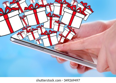 buying christmas presents by smartphone and drawn gift boxes blue background