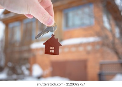 Buying a country house, summer cottage in winter, in the hands of the key. - Shutterstock ID 2120392757