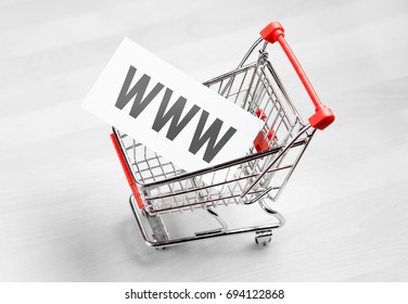 Buying Domain Name For Company Website. Online Shopping, E Commerce And Internet Store Concept. Newsletter And Email Marketing. Miniature Shopping Cart With Www Letters.