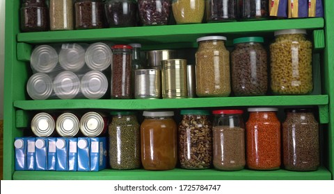 Buying food in bulk during the coronavirus lockdown period. Home pantry shelves with long-term storage and canned products - Shutterstock ID 1725784747
