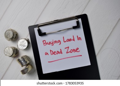 Buying Land In A Dead Zone Text Write On Paperwork Isolated On Office Desk.