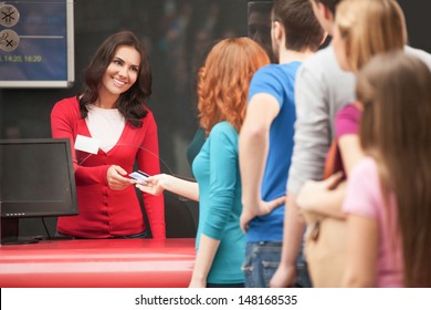 Buying The Movie Tickets. Young People Waiting In Line To Buy The Movie Tickets