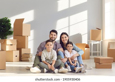 Buying new apartment and real estate for family concept. Happy family with son and daughter sitting together on floor and hugging together feeling positive with relocating to new home