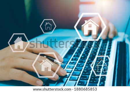 Buying, selling and renting houses or real estate concept, property online, hands typing on computer laptop as background