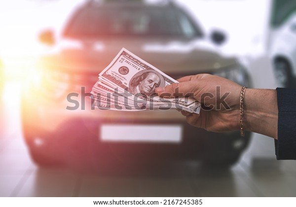 buying an SUV in a good car dealership from a friend\
at a discount. Men exchange keys and money. The concept of buying a\
car