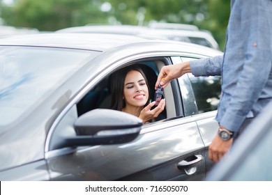 Buying Used Car. Car Dealer Inventory. Used Cars Store. Male Wants To Buy The Car. Close-up Of Hand With A Wrist Watch, Holding Key From Auto, Finance For Car Concept. Happy Life. Blurred Background.