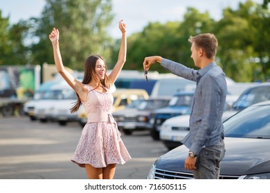 Buying Used Car. Car Dealer Inventory. Used Cars Store. Male Wants To Buy The Car. Close-up Of Hand With A Wrist Watch, Holding Key From Auto, Finance For Car Concept. Happy Life. Blurred Background.