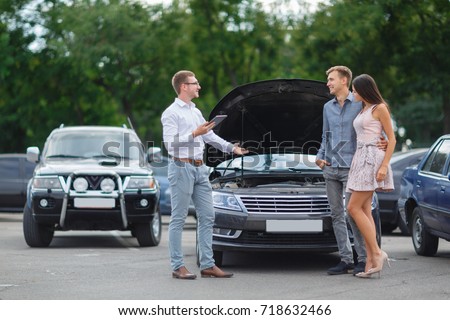 Buying used car. Car Dealer Inventory. Used cars store. Male wants to buy the car. Happy life. Summer time. Young family. Communication with the seller from auto for sale.