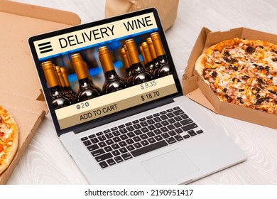 Buying Wines Online, Home Delivery Concepts. Screen Laptop Computer On Table With Wine Bottle