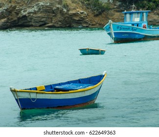 BUZIOS, BRAZIL – FEBRUARY 25, 2017: Fishing boats at anchor in the harbor of the resort city on the Atlantic coast including a dory-like boat popular with local fishermen.