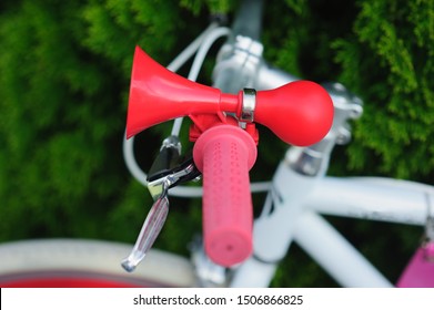 Buzzer On The Bike. Red In Retro Style. On A White Bike. Pedestrian Safety And Warning Concept. Red Horn, Horns, Buzzer, Beep.