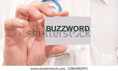 Buzzword word on the card in a man's hand on the background of a white shirt