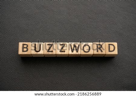 Buzzword - word wooden blocks with letters, Buzzword popular word or phrase concept, black leather background