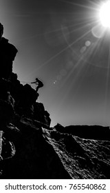 B/W of man rappelling 