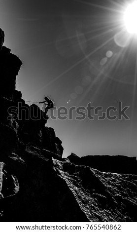 B/W of man rappelling 