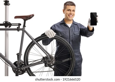 Bycicle Mechanic Smiling And Holding A Mobile Phone Isolated On White Background