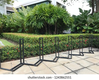 Bycicle Parking Lot In The The Park Full Of Plants