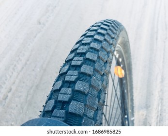 Bycicle Wheel Close Up On Neutral Sand / Snow Background
