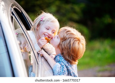 Bye Bye. Little Boy Say Good Bye With Little Girl. Farewell Concept. Gives Warm Kiss. Couple Saying Goodbye Before Car Travel