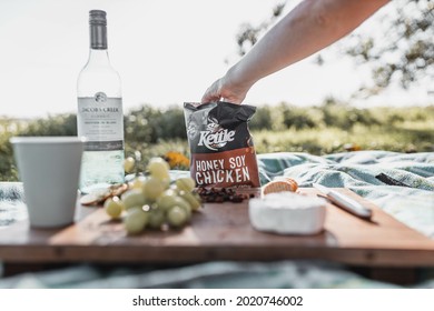 BYRON BAY, AUSTRALIA - Jan 25, 2021: A Cheese Platter With Kettle Chips And Jacob's Creek Wine