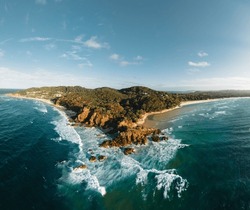 Byron Bay Lighthouse And The Pass High On The Rocky Headland - The Most Eastern Point Of Australian Continent Facing Pacific Ocean In Elevated Aerial Seascape Above Coast.
