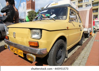 BYTOM, POLAND - SEPTEMBER 12, 2015: People admire Polski Fiat 126p during 12th Historic Vehicle Rally in Bytom. The annual vehicle parade is one of main events of this type in Poland.
