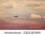 C130 cargo plane dropping parachute 