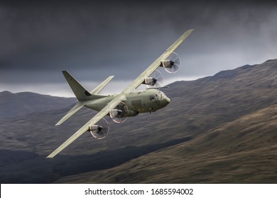 C-130 Hercules combat transport aeroplane flying low level in the UK low fly system in mid Wales called the Mach Loop. Royal Air Force C130