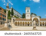 C16th Loggia di San Giovanni, Udine, Italy. Renaissance and Baroque. Loggia. Centre: clock tower. Foreground: Justice Statue on a column, Peace Statue seated, Hercules Statue. Background: Udine castle