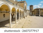 C16th Loggia di San Giovanni, Udine, Italy. A blend of Renaissance and Baroque. Loggia. Right: C16th multi-tiered cascading fountain, San Marco lion on a column. Background: Udine cathedral belltower