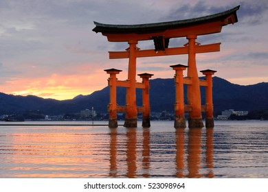 The c.500-600 years old-camphor tree-rotting resistant-vermilion lacquered main pillars+cedar tree sleeve pillars Itsukushima shrine Great Torii-gate at dusk-half tide. Miyajima-Hatsukaichi city-Japan - Powered by Shutterstock