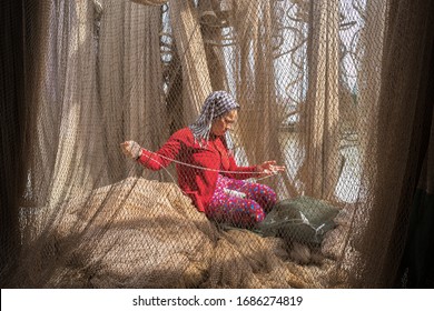 Ca Mau, Vietnam - Dec 6, 2016: Casting Net With Vietnamese Woman Mending Casting Net On Background In Ngoc Hien, Ca Mau District, Vietnam