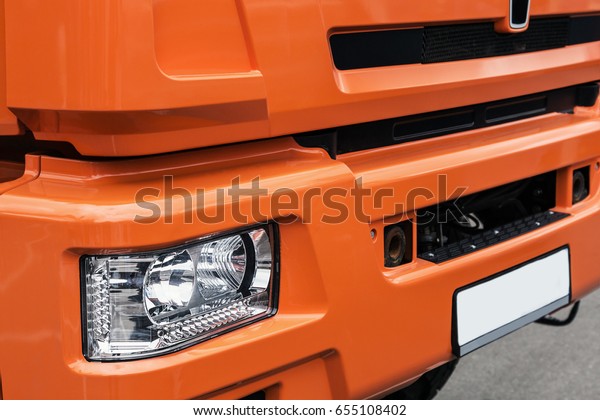 cab and bumper with the headlights of trucks.\
Focus on the headlight