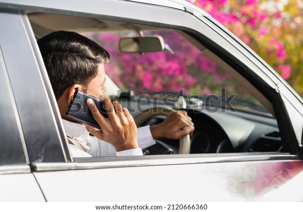 Cab driver from car asking customer\
adress on mobile phone call - concept of customer transportantion\
service, communication and taxi booking on\
call