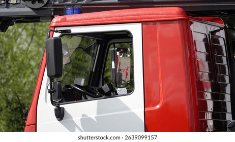 A cab of a fire engine with a blue blinker