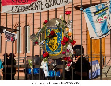 CABA, Buenos Aires, Argentina - 11 26 2020: Diego Maradona's Death. Wake And Vigil In Presidential Government Building Casa Rosada. Roses And Football Shirts Left By Fans Hanging From The Fences. 