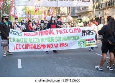 CABA, Buenos Aires, Argentina; Sept 24, 2021: Environmental Activism, People Marching. Banner Text: World Strike For The Climate, Nature Cannot Be A Commodity, Capitalism Is No More.