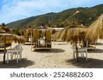 Cabana on beach and mountain in background