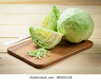 cabbage and cutted cabbage on wooden