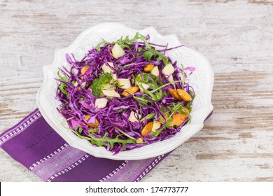 Cabbage salad. Red cabbage salad filled with nuts, broccoli , apples and fresh herbs. Macro, selective focus - Powered by Shutterstock