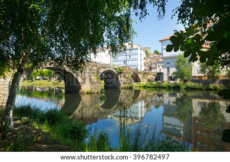 Cabe river and old stone bridge at Monforte de Lemos in sunny day. Galicia, Spain
