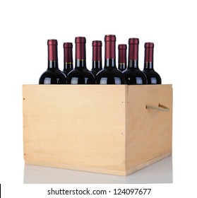 Cabernet Sauvignon wine bottles in a wooden crate. Vertical format isolated on white with reflection.