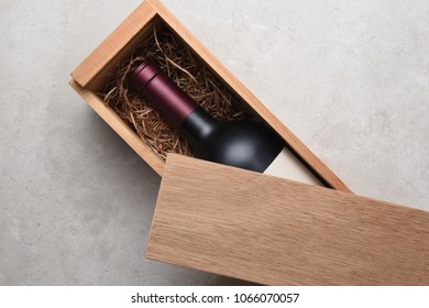 Cabernet Wine Box: A single bottle of red wine in a wood box partially covered by its lid.