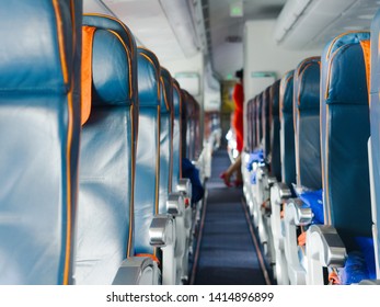 Cabin Airliner, Blue Leather Seats, Passage Between The Seats. Blurred Background, Flight Attendant Doing Pre-flight Training